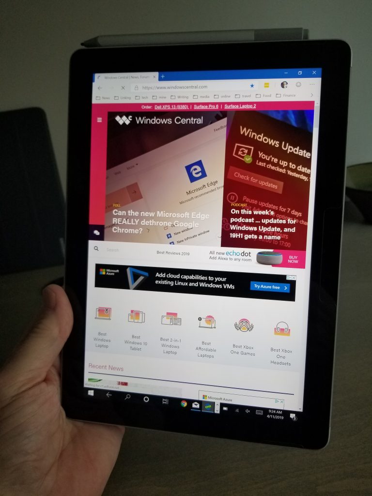 holding a surface go in one hand